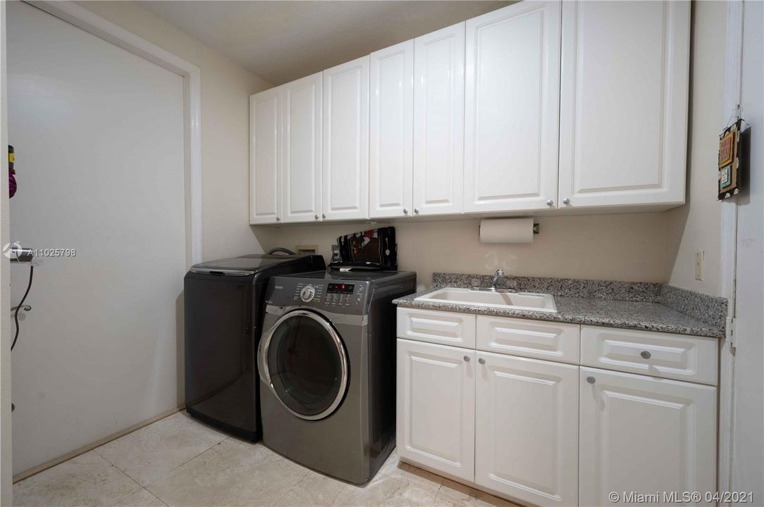 Full laundry room with entrance to one car garage