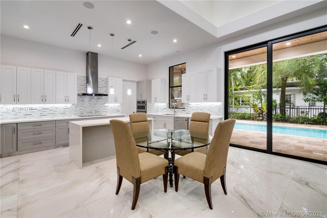 Kitchen and dining area with views to the pool
