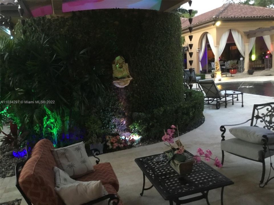 patio sitting area with private enclosed jacuzzi area behind vine covered wall
