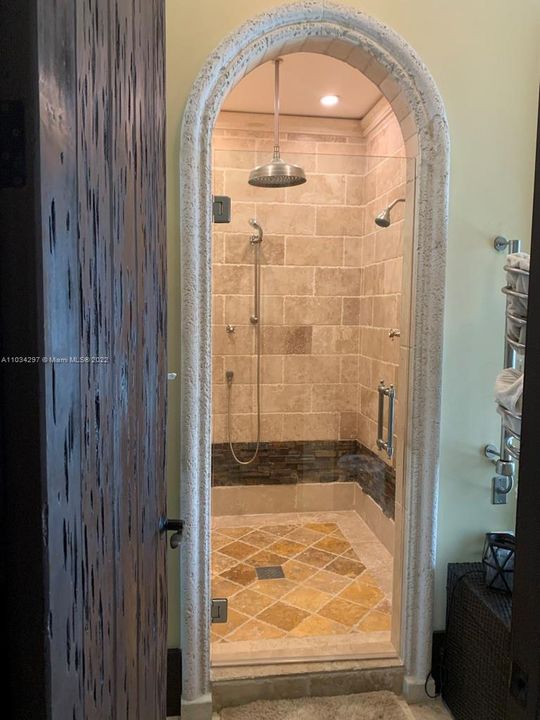 Cabana shower with 4 shower heads and Electric towel warmers on either side