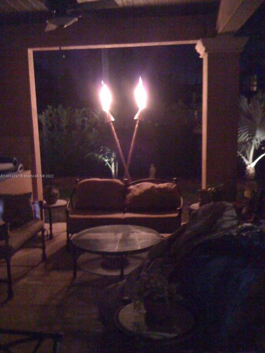 One of 3 sets of in-line gas Tiki Torches around patio