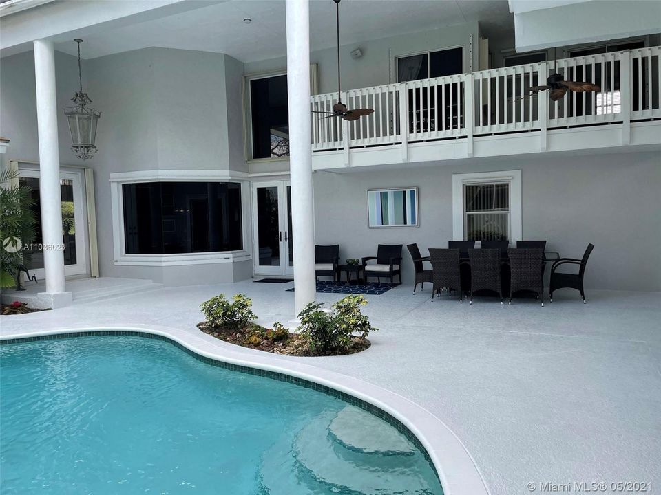 Beautiful Pool Deck Area with upper floor balcony and lower dining area no mater what the weather.