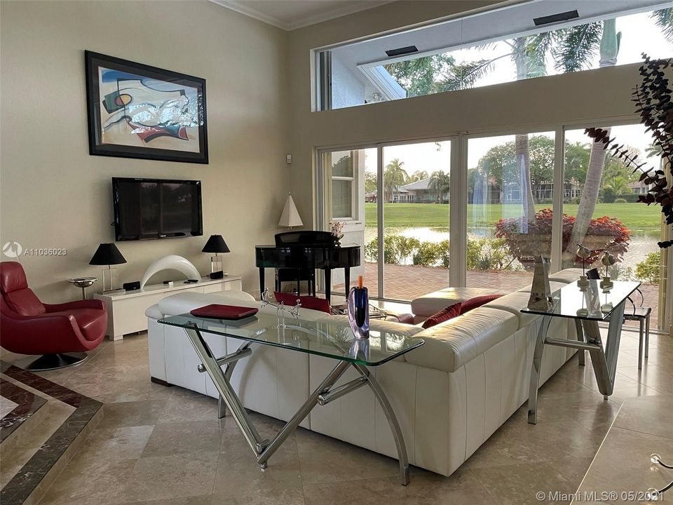 Living Room showing Marble Floors and beautiful view of canal and golf course at sunrise