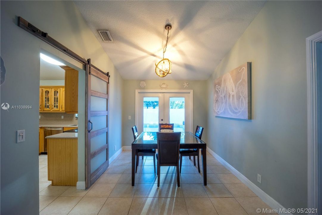 Dining Room w/ Vaulted Ceiling and Barn Door closure to Kitchen