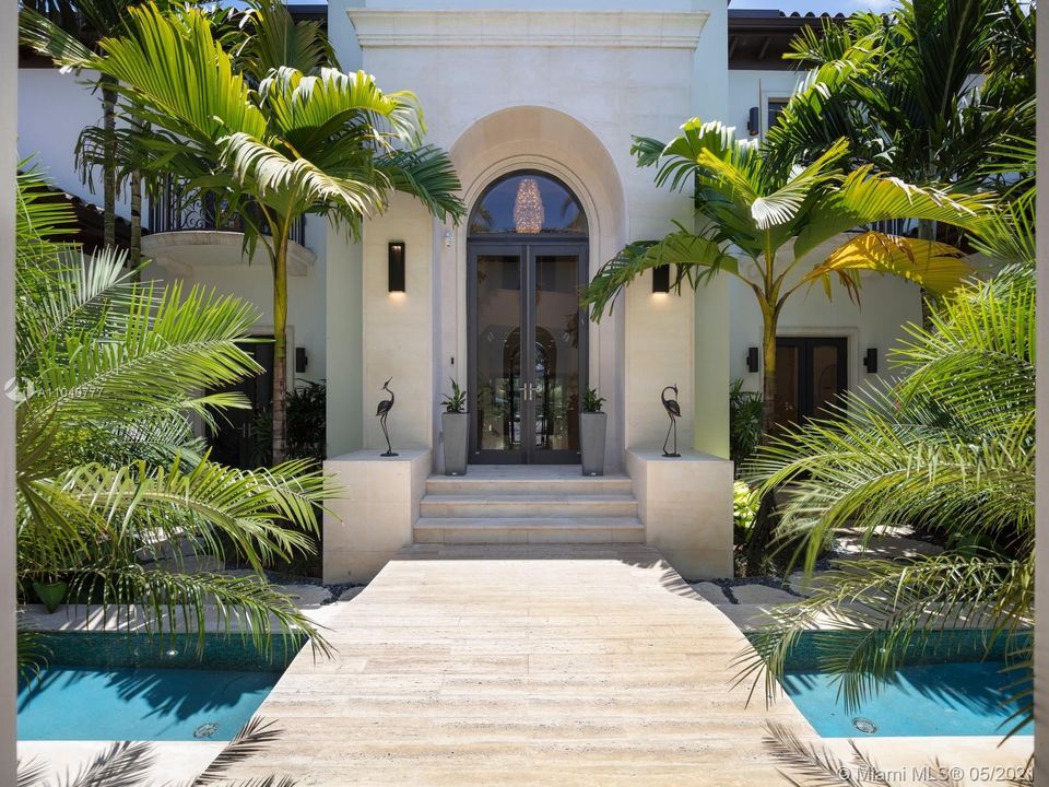 Gated foyer entry with Zen water features, Juliette balconies, and elegant double door soaring foyer entry.