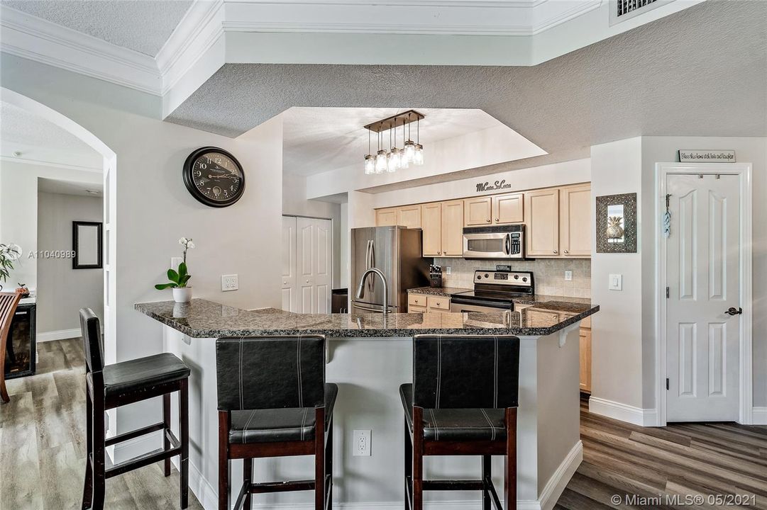 Kitchen with granite countertops and stainless steel appliances.