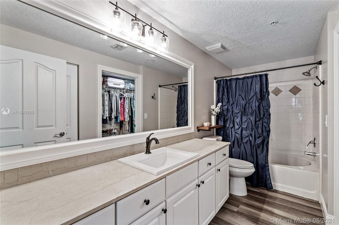 Master bathroom with linen closet and walk in closet.