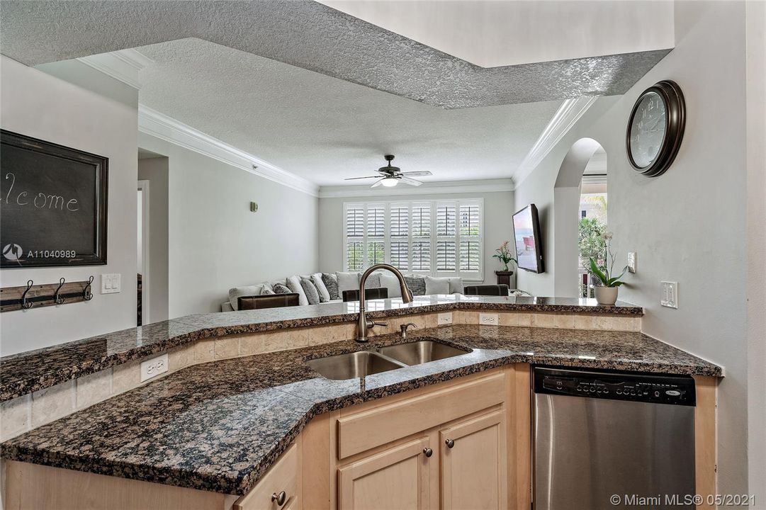 Eat in kitchen granite countertops open to living room.