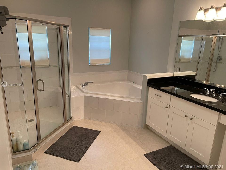 Separate shower and Roman tub in the main bathroom.