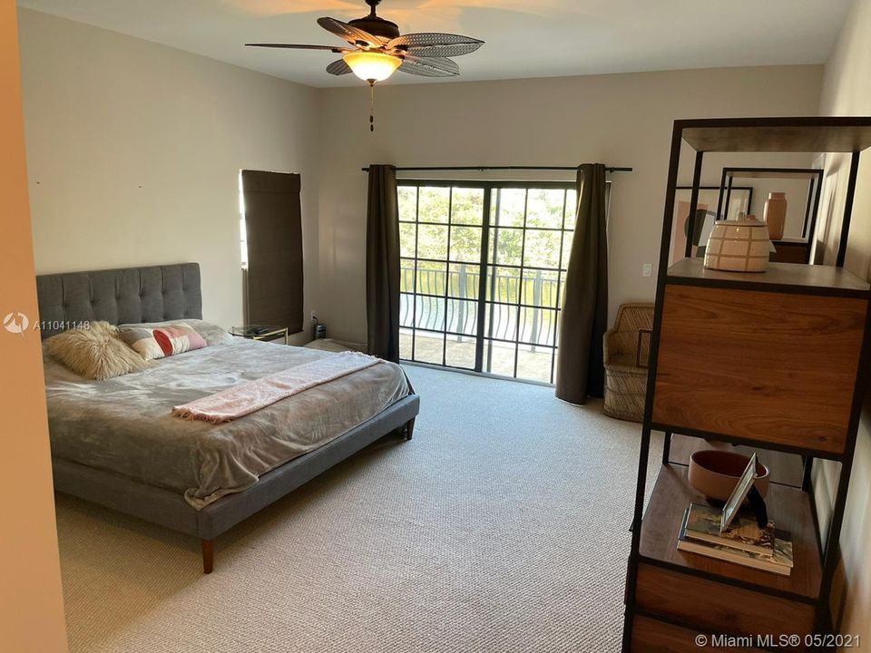 The expansive master bedroom looks out towards the water.  It features its own balcony.