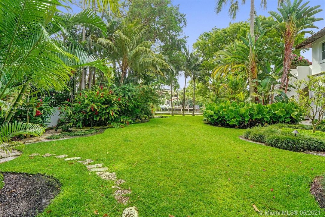 The most unique yard in all of Colee Hammock with 150ft on the canal. 3/4.5 main house and a 2/2 guest house this is a gem of a property you typically would find in Coral Gables or Palm Beach.