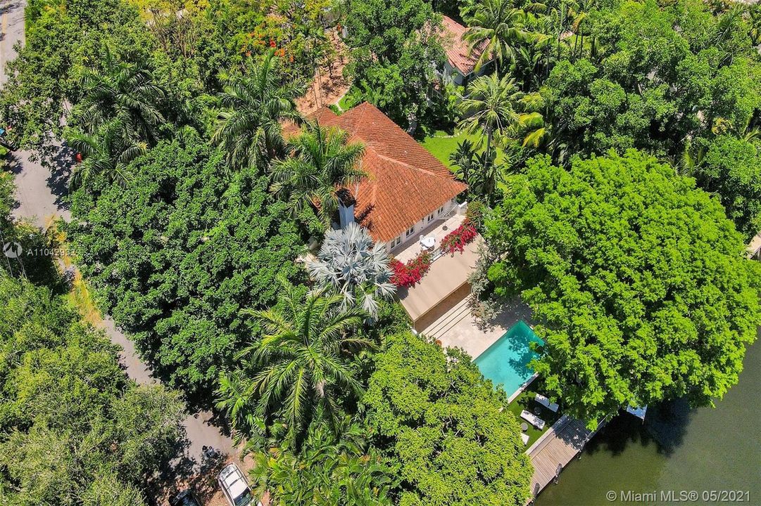 over 1/2 acre with large Mahogany tree that provides the forever grass sundeck with partial shade. 150' on the canal