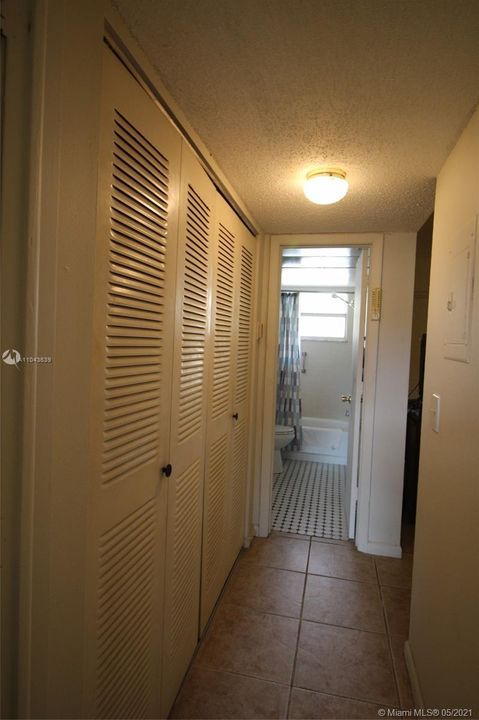 Hallway from bedroom to bath. Large closet.