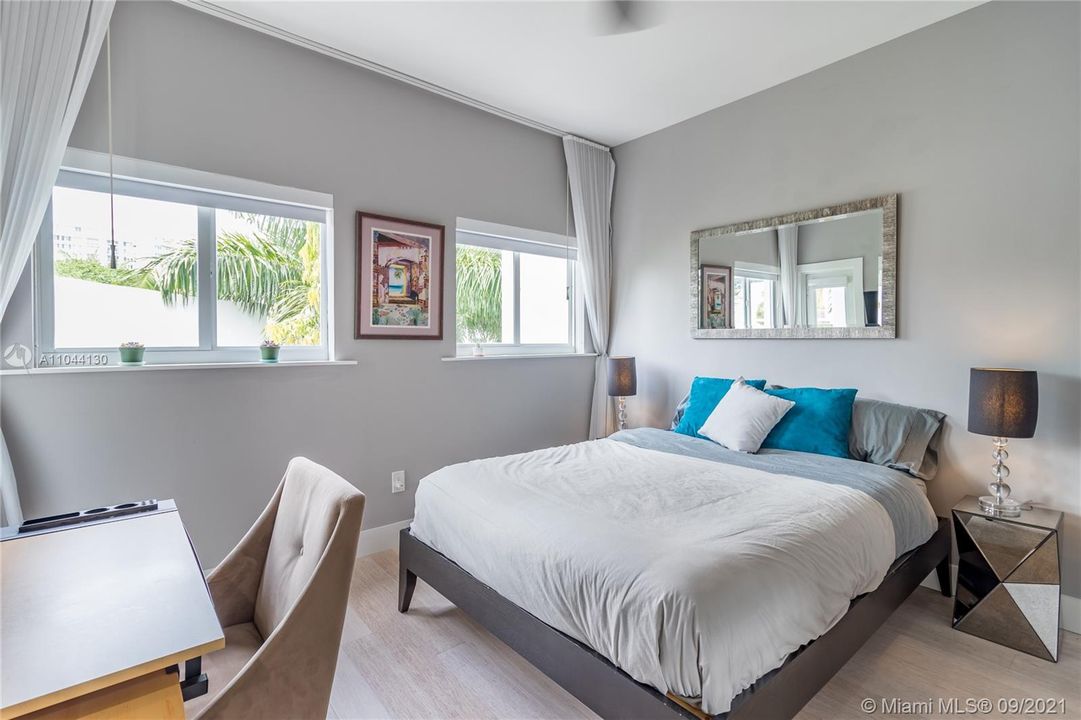Third level spacious bedroom with en-suite full bath, large walk-in closet and private west facing patio overlooking lush mature landscaping