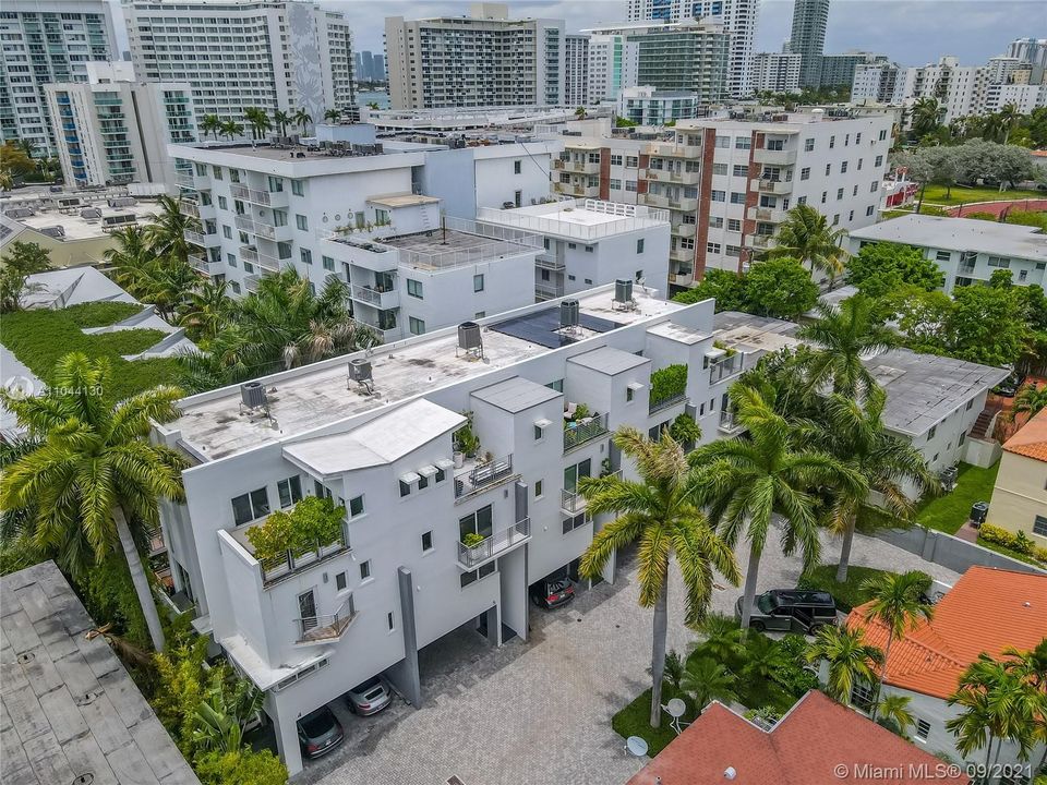 corner residence with three exposures, four outdoor spaces (on every level) just steps two blocks from Biscayne Bay in the quiet Flamingo Park neighborhood.