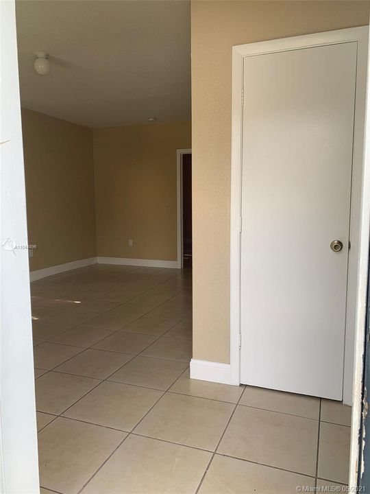 Entry closet with living spaces to right and left.