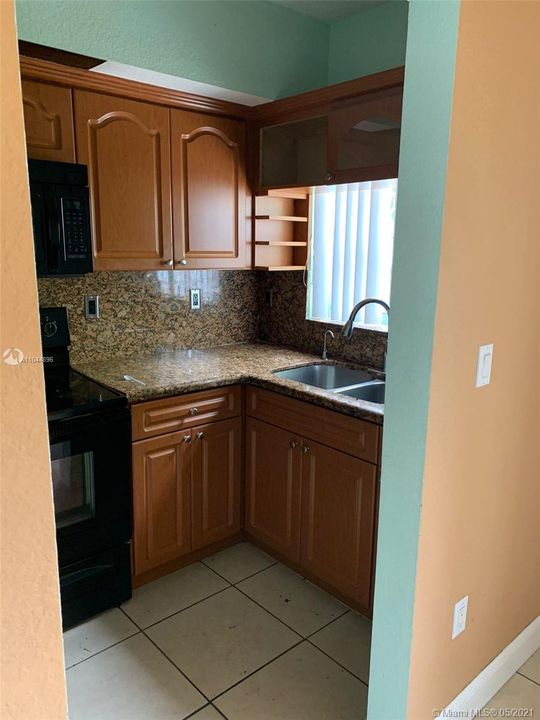 Kitchen with stainless steel undermount sink and granite countertops.