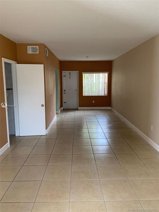 Living space 2 with half bath to the left and kitchen at the end.