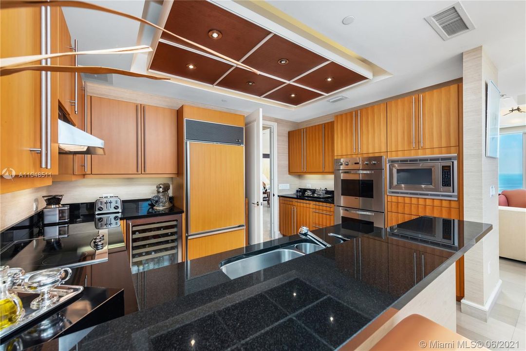 Poggenpohl pearwood cabinetry, with double ovens, microwave, Sub-Zero Fridge and wine cooler