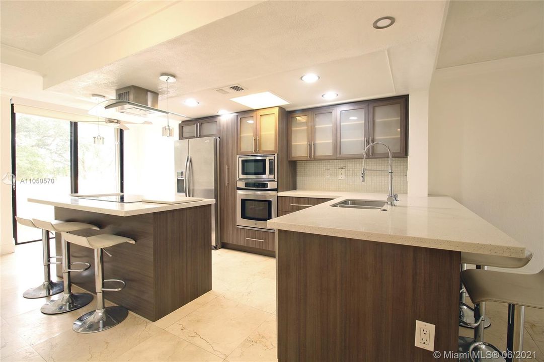 Fully updated kitchen with double oven and seating for 7 people.