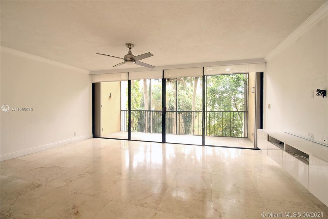 Living room opens to a big screened balcony.