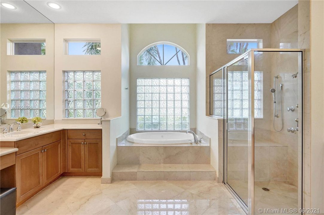 Lovely combination of wonderful marble, graceful shapes and wonderful transparency in this Master Bathroom