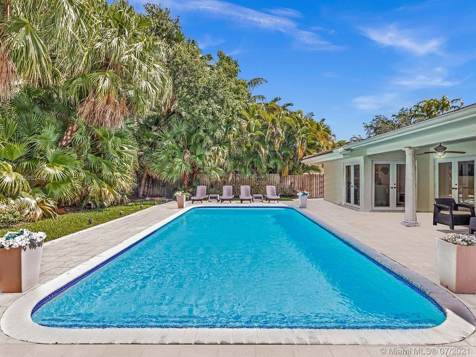 OVERSIZED 12,600 SF LOT FEATURES LARGE CUSTOM POOL THAT WAS RECENTLY RESURFACED, PLENTY OF GRASS AREA TO PLAY, BEAUTIFUL LUSH TREES AND FOLIAGE, AND OVER HANG FOR SHADE WITH SPACE FOR SUMMER KITCHEN.