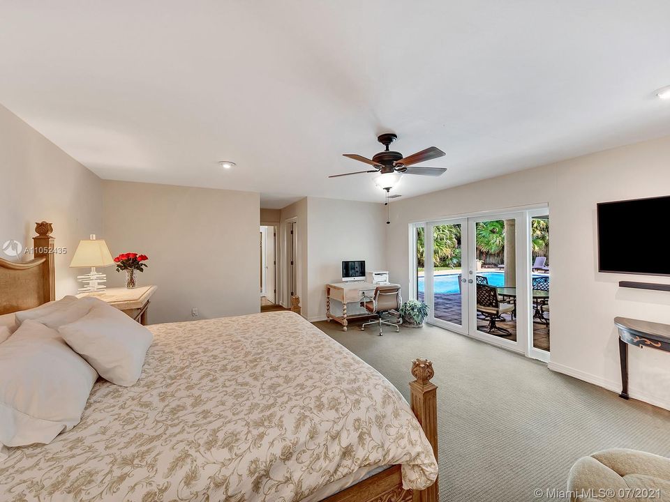 THE MASTER SUITE OVERLOOKS THE POOL AND OFFERS PLENTY OF SPACE FOR SEATING AND AN OFFICE. TWO WALK IN CLOSETS AND A LARGE SPA LIKE BATHROOM HAS PLENTY OF FEATURES FOR PLENTY OF ENJOYMENT.