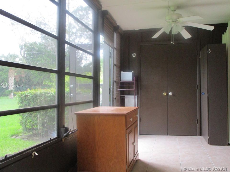 Washer/dryer at end of room behind door