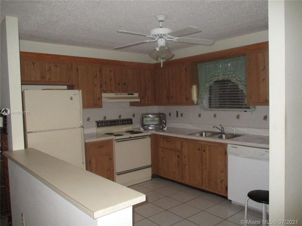 Kitchen opens into living/dining area