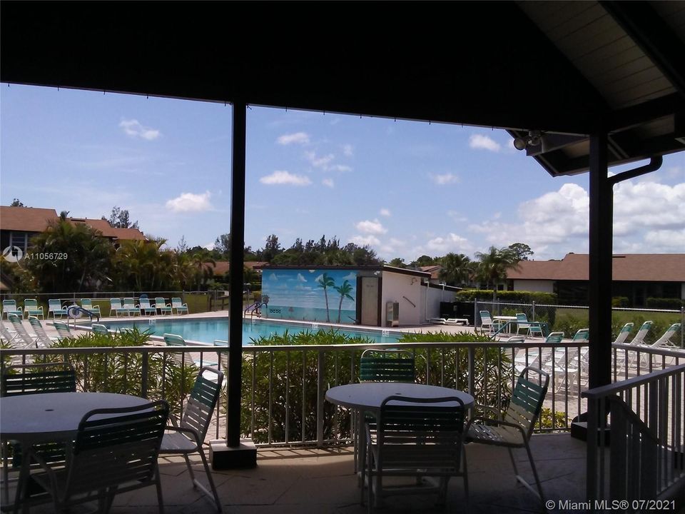 A shaded area with tables by pool.