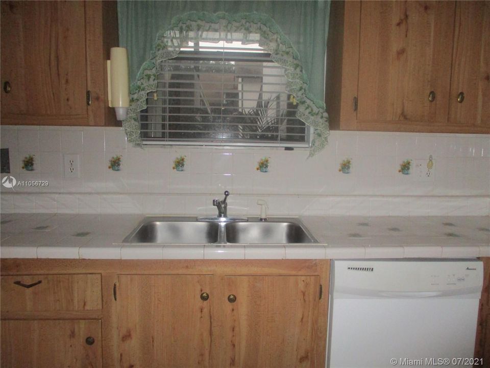 Double sink with window viewing the palm plant