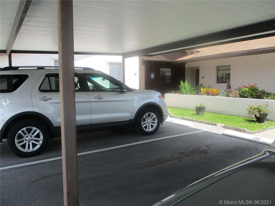 Covered carport parking spot in front of C101