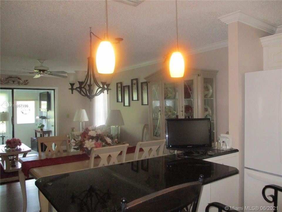 Open concept from Kitchen with 2 over size stools that extends into dining/living area.