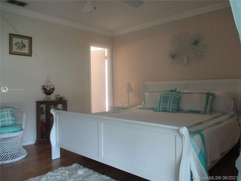 Master bedroom with white framed King size adjustable bed