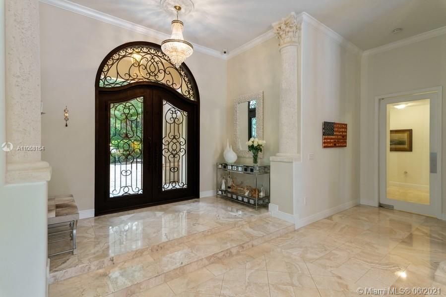 Foyer to home with elegant and iron and impact door.