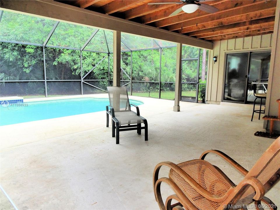 Wood studded lanai adds just the right amount of a rustic feel.  You are surrounded by beautifully wooded land