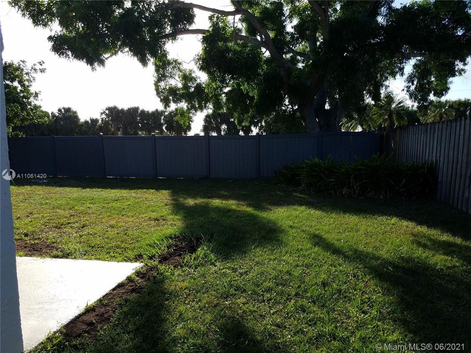 Partially fenced spacious backyard.