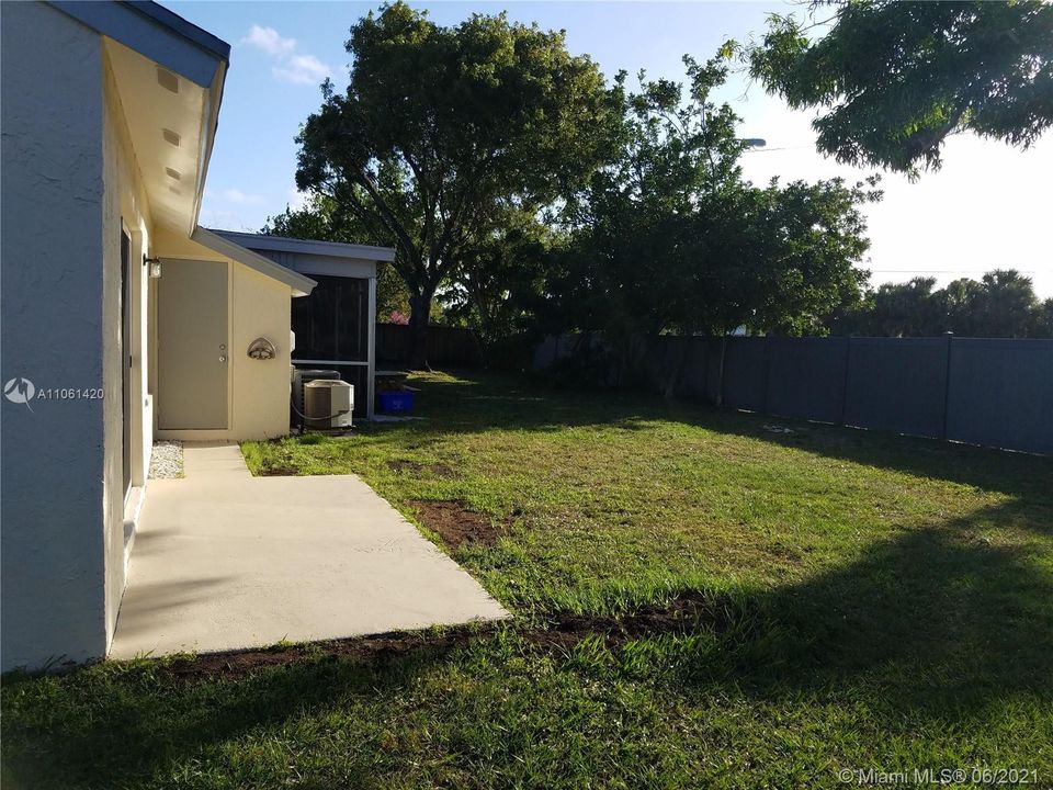 Backyard, open patio and door to attached shed.