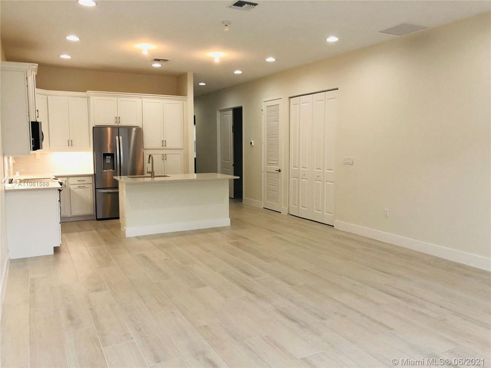 Wide view of Foyer & Kitchen