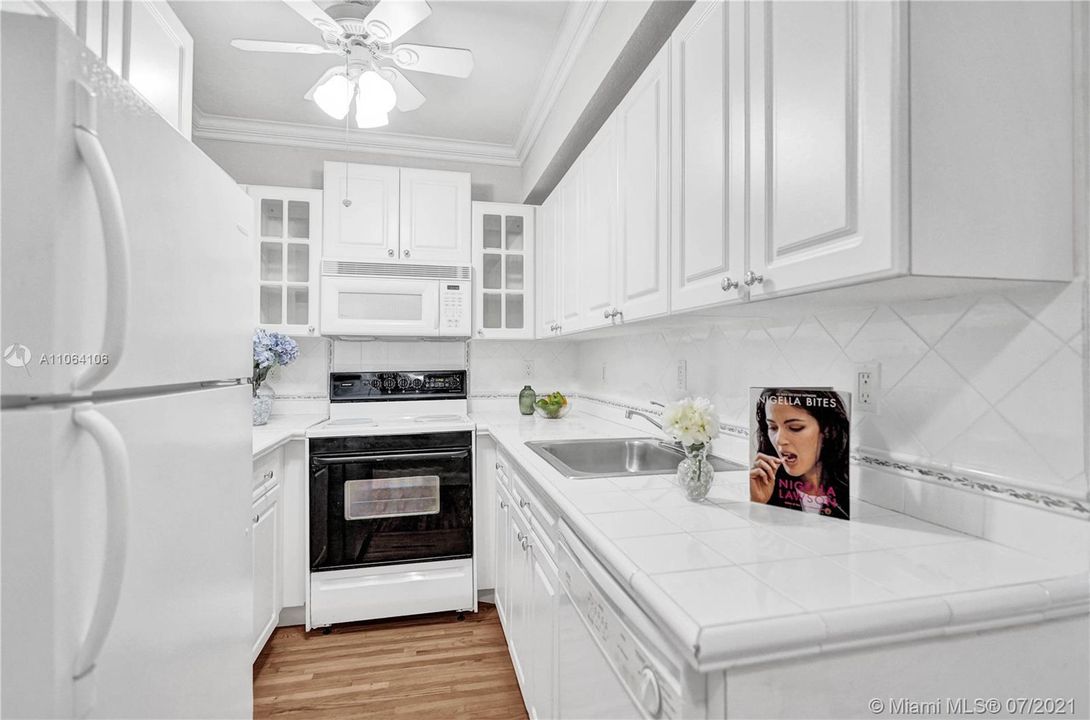Bright, light & white kitchen with dishwasher & microwave awaits the budding chef
