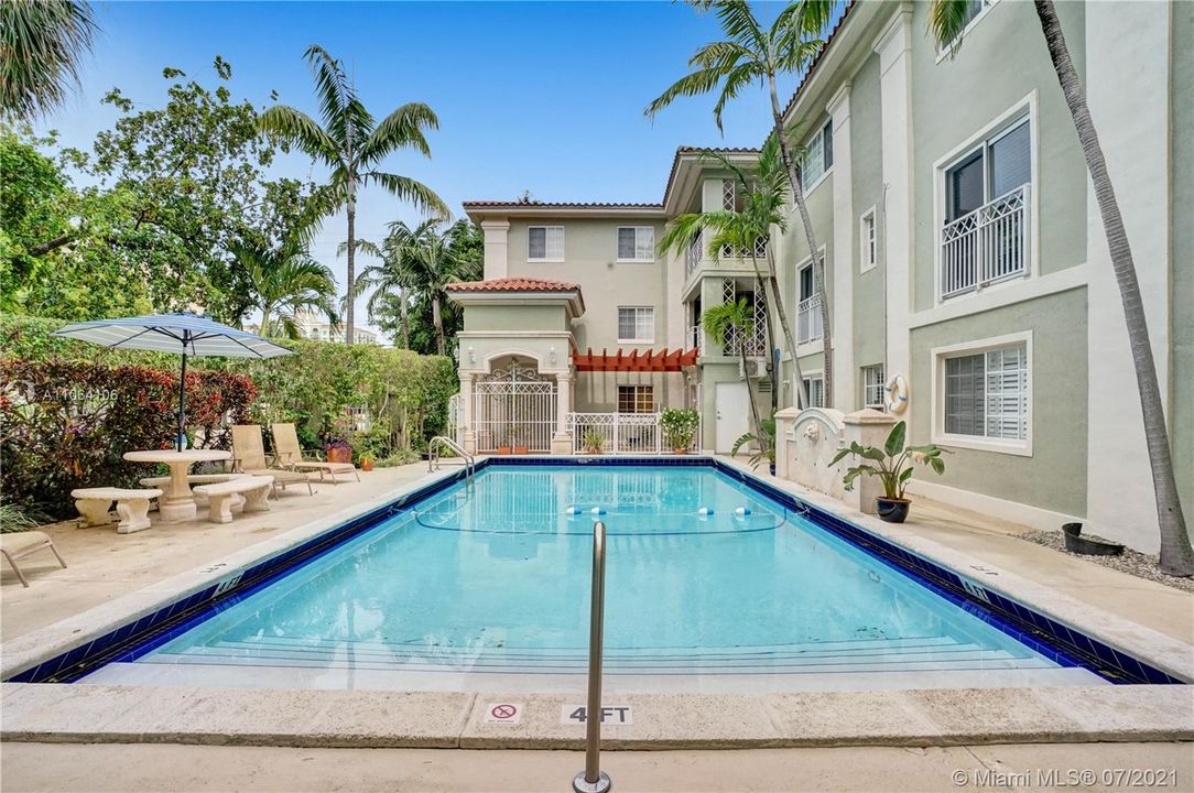 Enjoy this beautiful pocket of serenity as you relax poolside at this charming, Spanish inspired Coral Gables condo