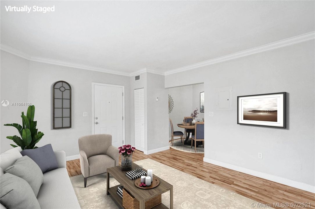 The inviting & ample living space welcomes with its newly refinished, light, hardwood floors