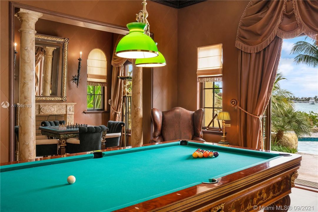 Billiards room with french doors leading to pool area