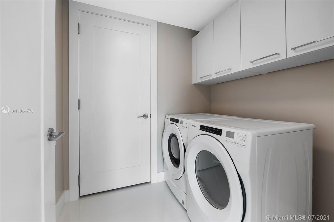 Laundry room and Utility Closet with cabinets above