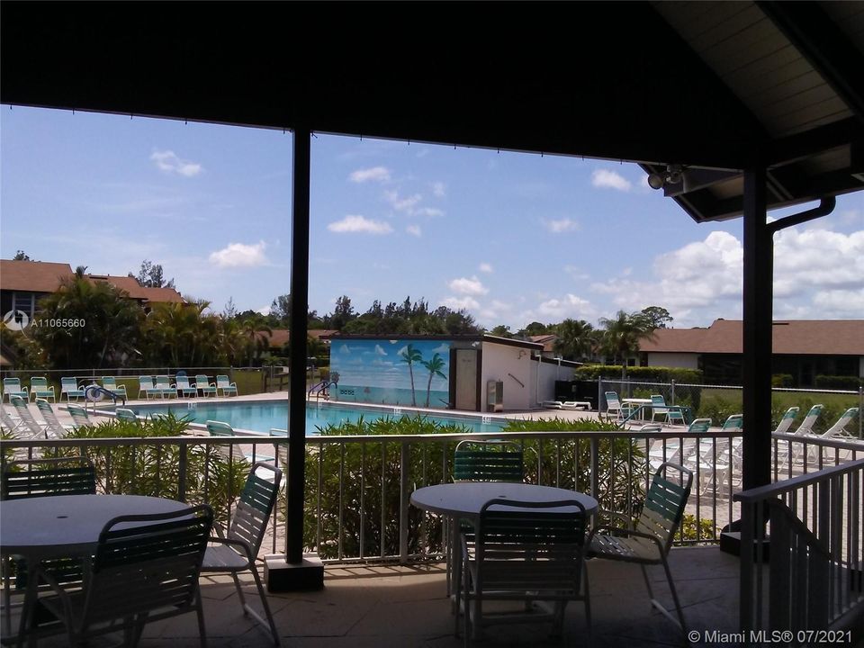 Shaded area with tables by pool