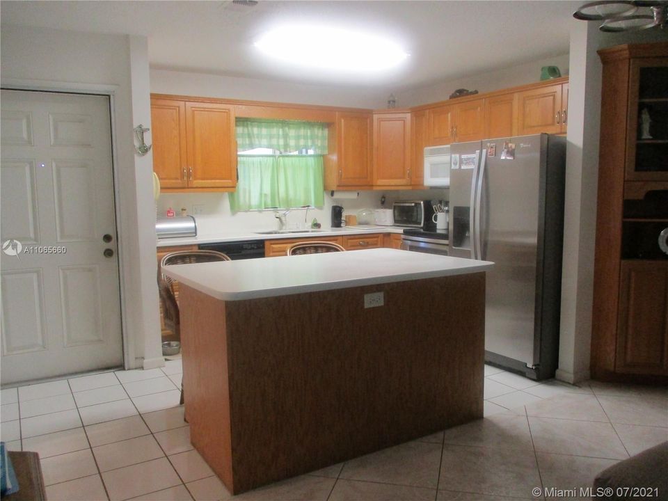 Kitchen with maple cabinets and corian countertops