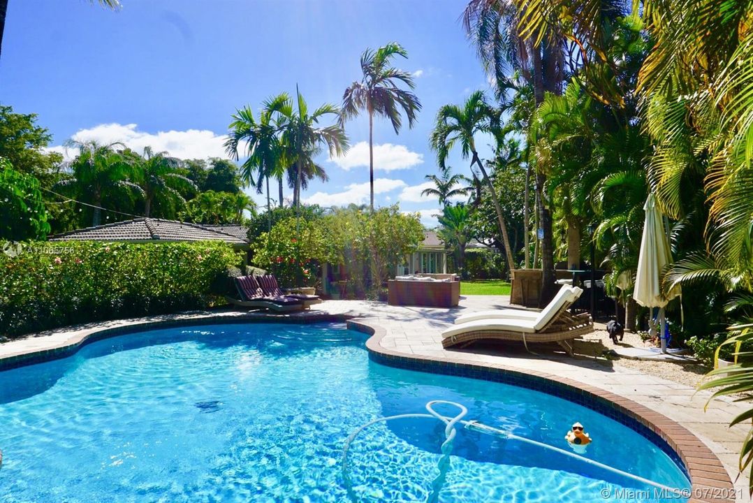 Sparkling pool nestled in spacious backyard uncommon in Pinecrest by the Sea