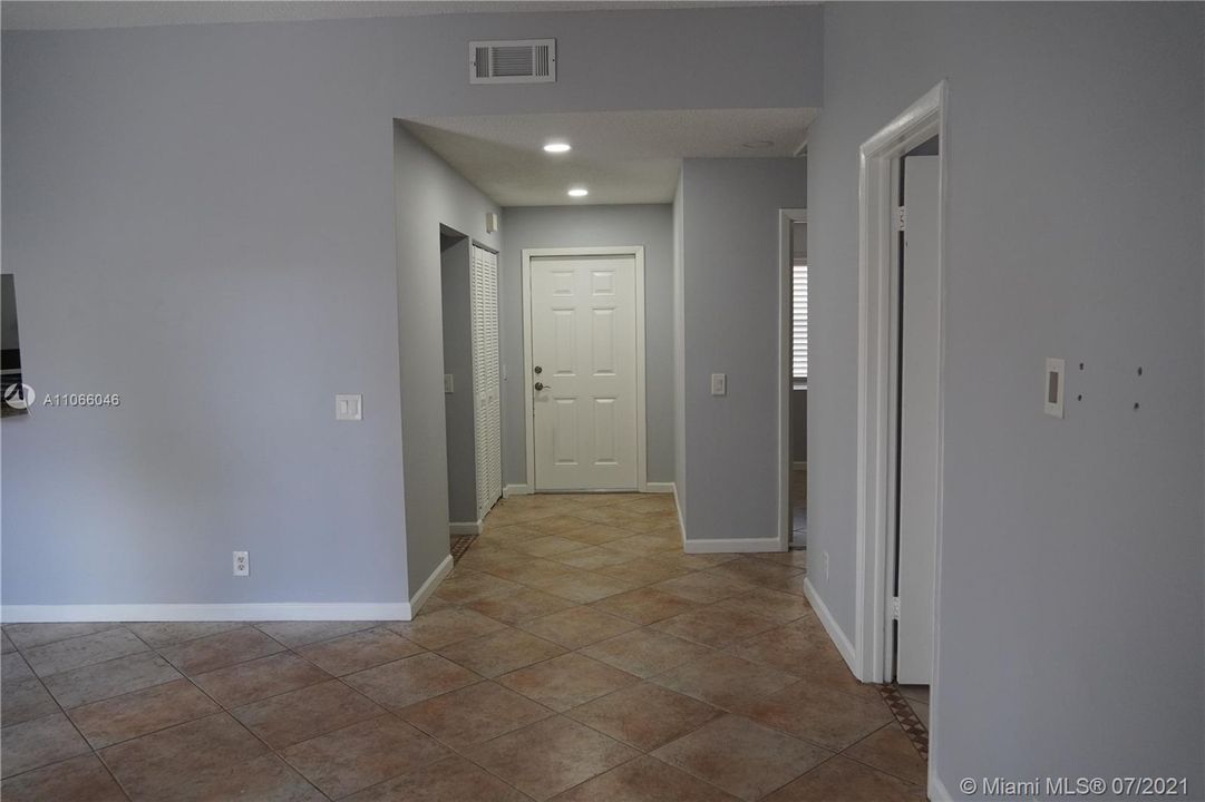 VIEW OF THE ENTRANCE DOOR FROM THE LIVING ROOM