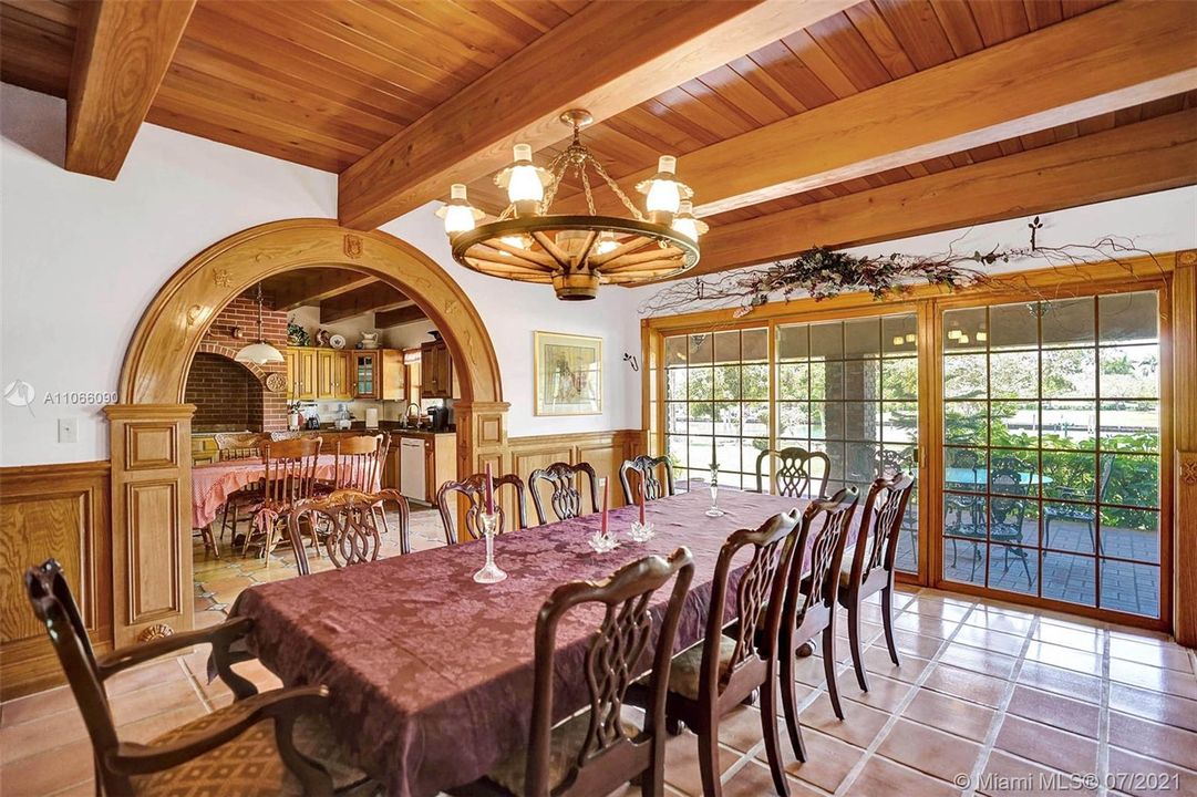 Formal dining area with custom arch and wood beam ceilings